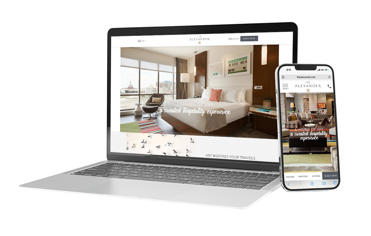 A laptop and smartphone display a hotel website featuring a modern hotel room with city views and inviting decor.
