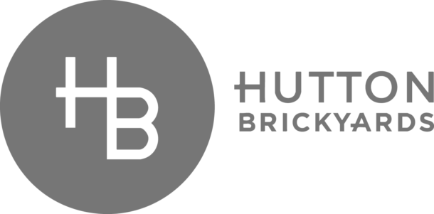 Gray Hutton Brickyards logo with stylized HB in a circle on the left and HUTTON BRICKYARDS in uppercase text on the right.
