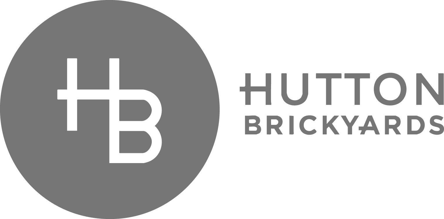 Gray Hutton Brickyards logo with stylized HB in a circle on the left and HUTTON BRICKYARDS in uppercase text on the right.